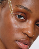 model applying Dusk Elixir active oil blend