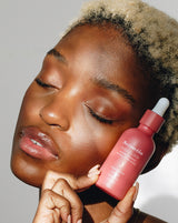 Model holding Dusk Elixir active oil blends