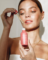 model applying Dusk Elixir active oil blend