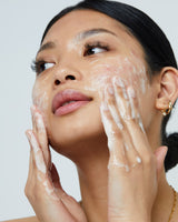 model applying Pure Clarity Deep Clean PHA Cleanser